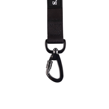 Black attachment buckle with locking feature. 